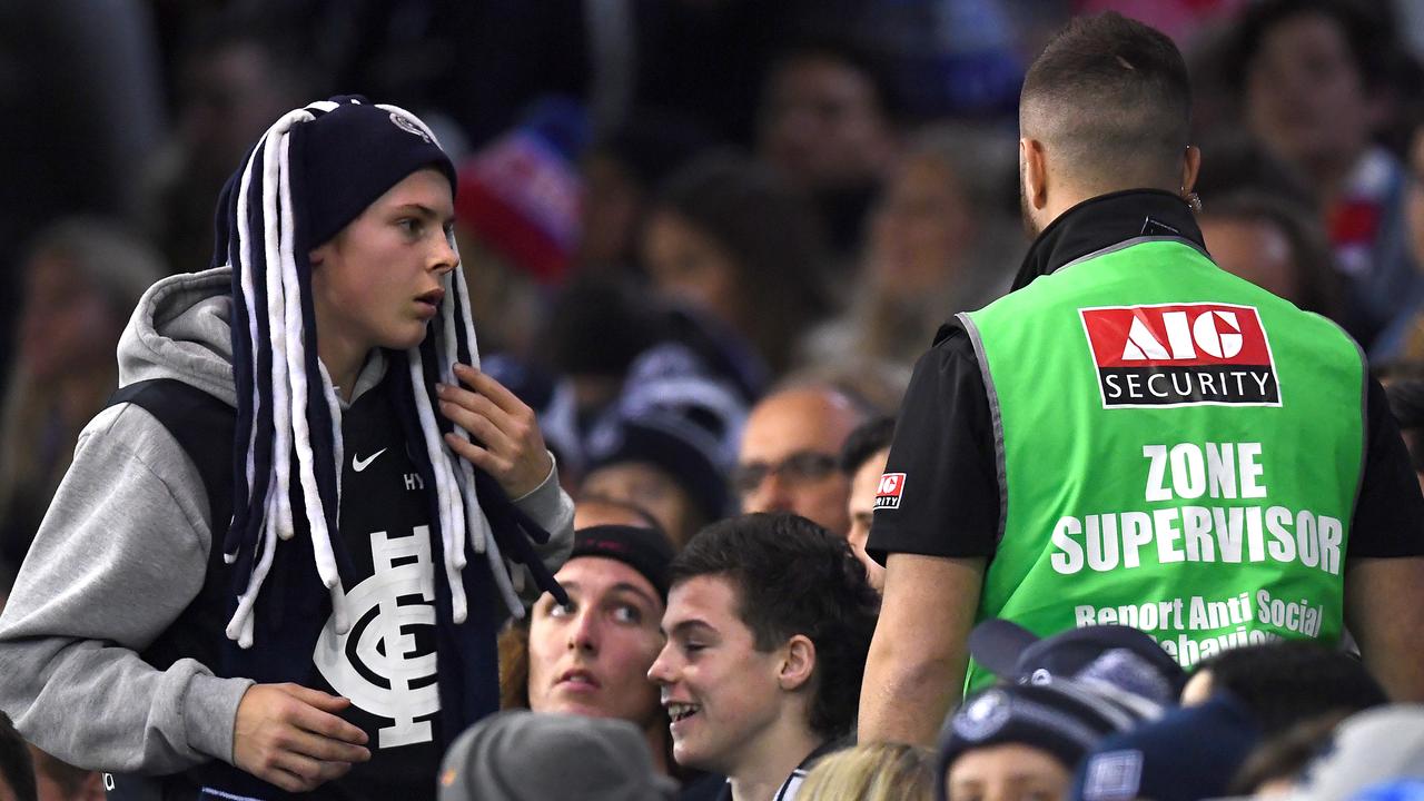 MELBOURNE, AUSTRALIA - JUNE 15: Security remove a member from the crowd during the round 13 AFL match between the Carlton Blues and the Western Bulldogs at Marvel Stadium on June 15, 2019 in Melbourne, Australia. (Photo by Quinn Rooney/Getty Images)