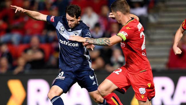 Melbourne Victory’s Robbie Kruse and Adelaide United captain Michael Jakobsen at Coopers Stadium.