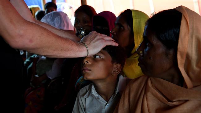 A nurse checks a boy with a fever for diphtheria at the Balukhali refugee camp near Cox's Bazar in Bangladesh in 2017. Picture: AAP