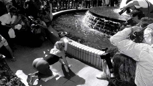 Actor Goldie Hawn putting her hands in cement at Movie World.