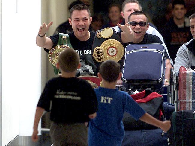 Kostya returns to Australia to see sons Tim and Nikita after his title win over Zab Judah in 2001. Picture: Supplied