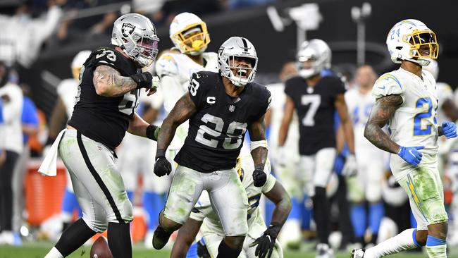 LAS VEGAS, NEVADA - JANUARY 09: Josh Jacobs #28 of the Las Vegas Raiders celebrates during overtime against the Los Angeles Chargers at Allegiant Stadium on January 09, 2022 in Las Vegas, Nevada. (Photo by Chris Unger/Getty Images)