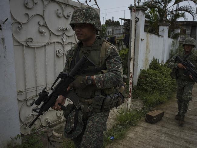 Philippine Marines soldiers walk towards the main battle area in Marawi. Picture: Getty