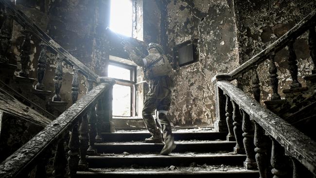 A Russian soldier inside the Mariupol theatre’s ruined shell. Picture: Alexander Nemenov / AFP