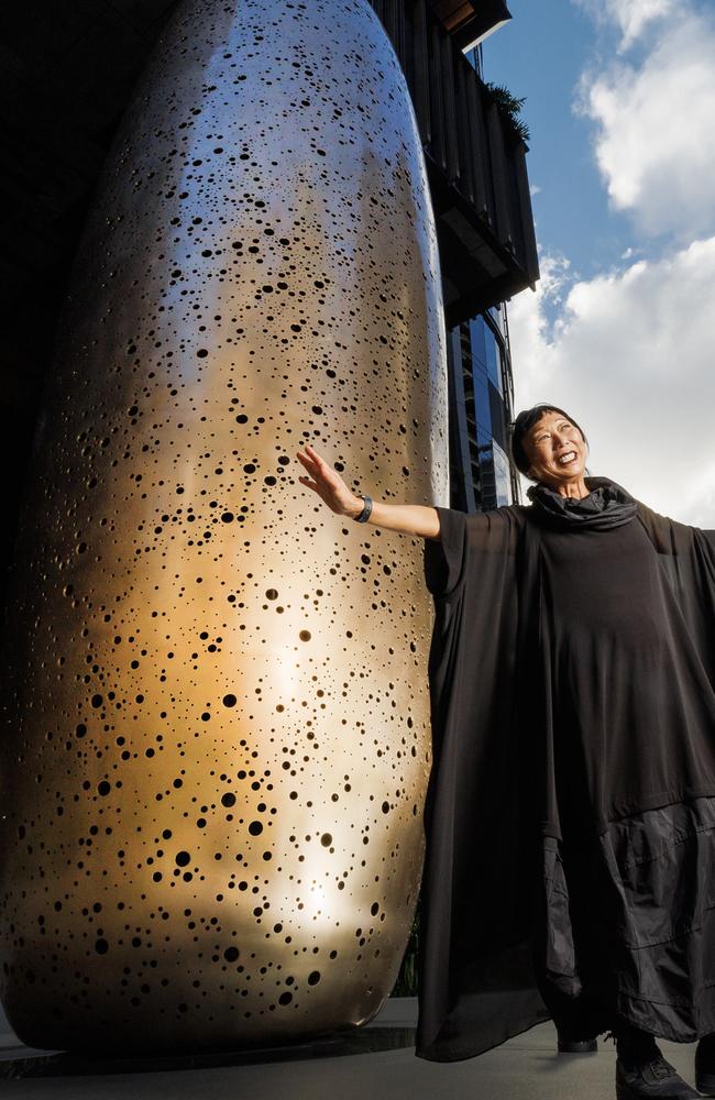 Artist Lindy Lee with her new work Being Swallowed by the Milky Way at the entrance to The Star Brisbane. Picture Lachie Millard