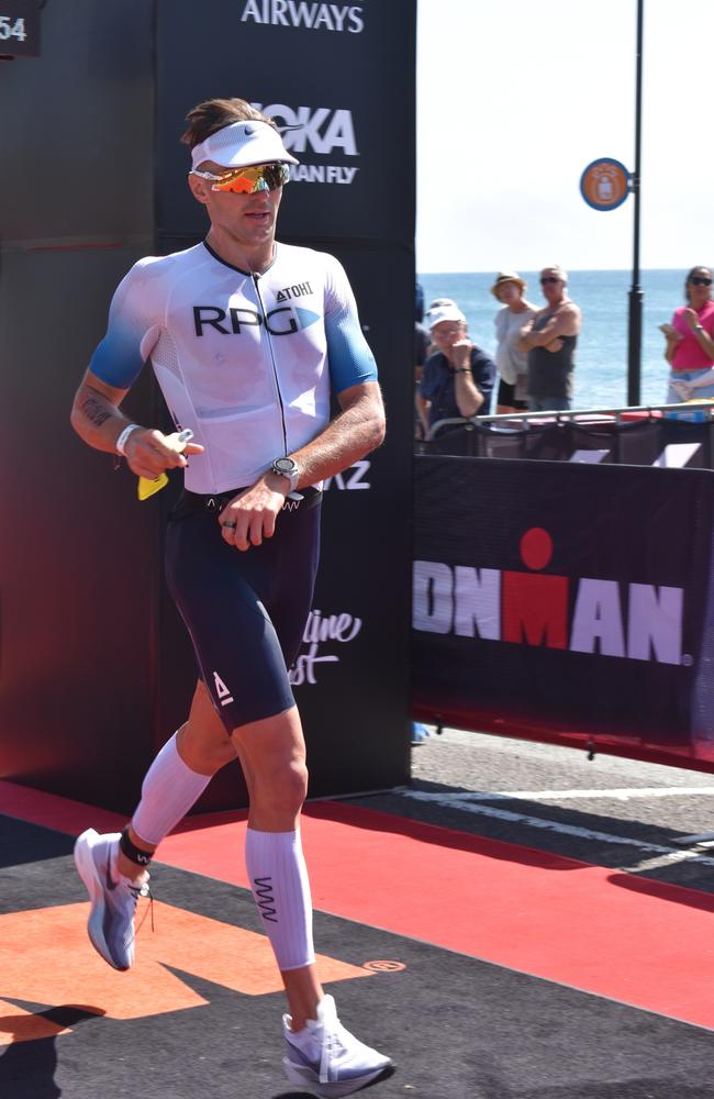 Athletes crossing the finish line at Sunshine Coast Ironman 70.3 2023.