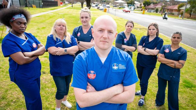 Geoff Hudson is an enrolled nurse but he is going to do his bachelor of nursing in Victoria after Victoria offered free HECS for nurses. Geoff pictured with fellow nurses Sue Ngalande, Liz Clarke, Bec Dunn, Geoff Hudson, Sarah Daniel, Chloe Hyde, and Amita Mahida leading a protest at the Albury Base Hospital. Picture: Simon Dallinger