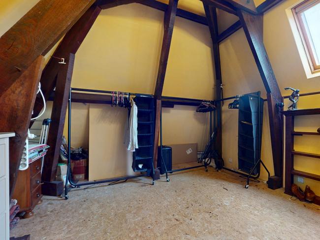 An enormous walk-in wardrobe-style attic features a bronze replica the Greek sculpture Discobolus of Myron.