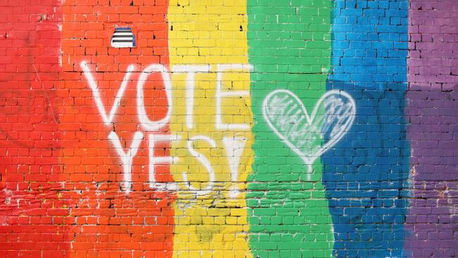 A wall painted with the rainbow flag and a message in Sydney’s Newtown.