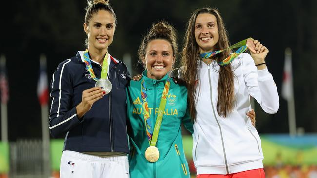 Silver medallist Elodie Clouvel of France, gold medallist Chloe Esposito of Australia and bronze medallist Oktawia Nowacka of Poland pose on the podium during the medal ceremony.