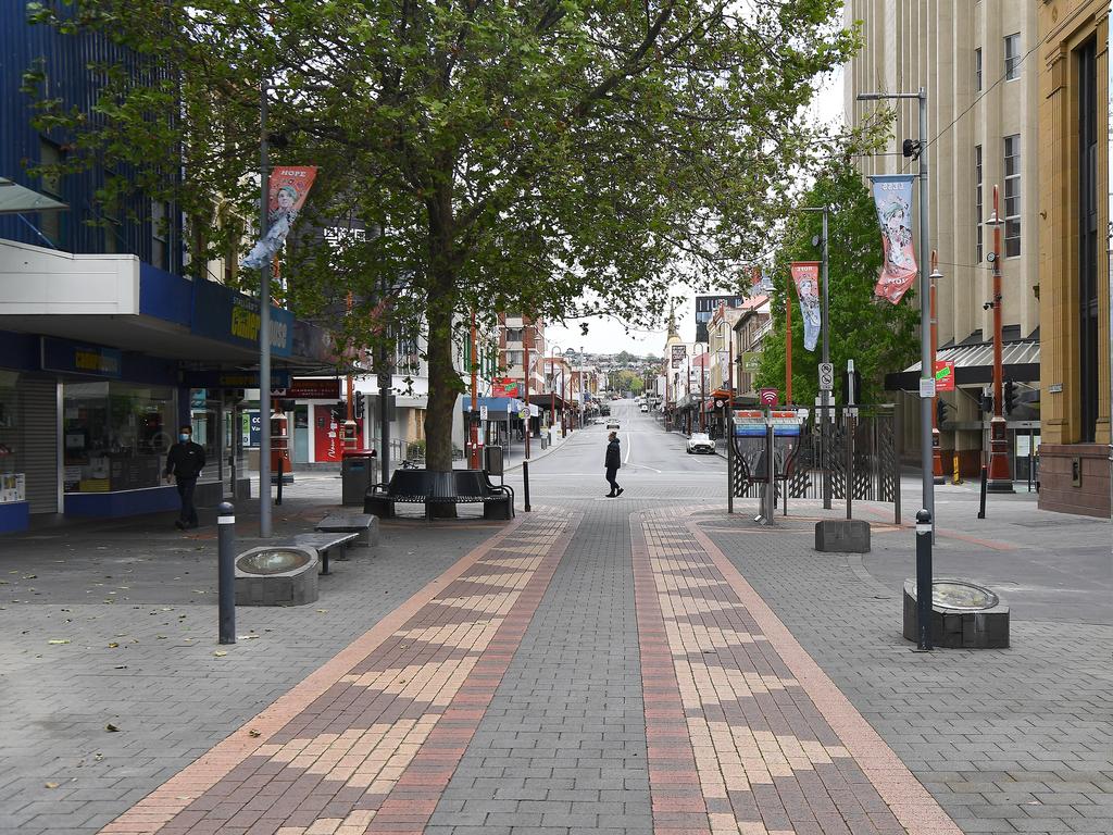 People walk along an empty street on October 16, 2021 in Hobart during a snap three-day lockdown. Picture: Steve Bell/Getty Images