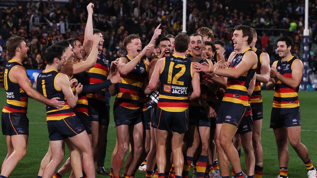 The Crows celebrate with the Showdown trophy. Picture: Sarah Reed/AFL Photos