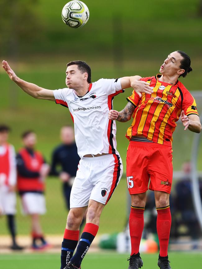 South Adelaide’s Donovan Pollock competes with ex-teammate and MetroStars attacker Liam Wooding during the sides’ clash on Saturday. Picture: AAP/Mark Brake