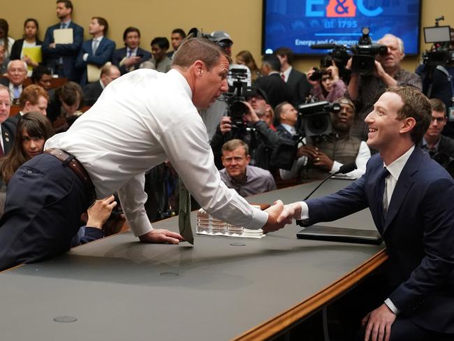 Facebook CEO Mark Zuckerberg, right, greets Republican Markwayne Mullin before he testified before a House Energy and Commerce hearing. Picture: AP