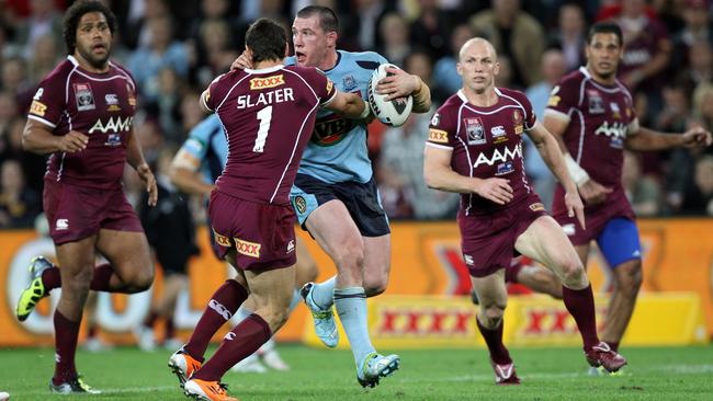 Gallen attempts to break through a Billy Slater tackle. Picture: Gregg Porteous