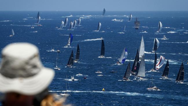 Spectators at North Head watch yachts start the race to Hobart. Picture: David Gray/AFP.