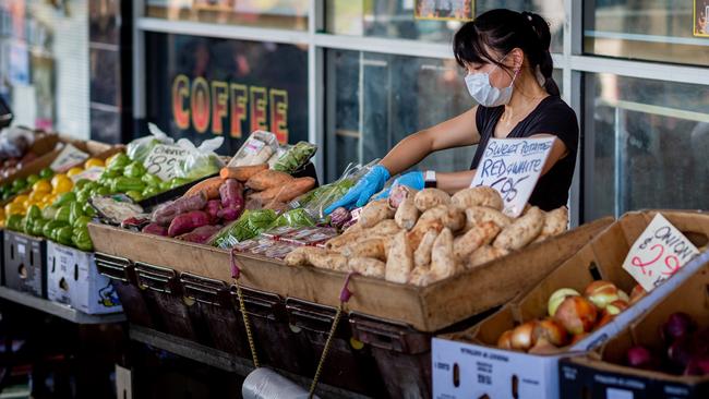 Stallholder Melody Zeuo at her vegetable stall at the Rapid Creek Markets, Darwin. Picture: Che Chorley