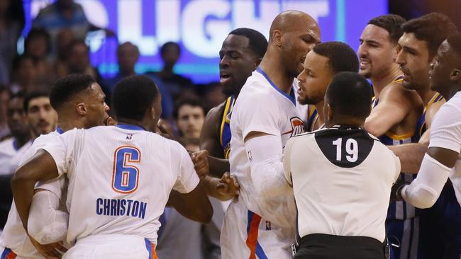 Oklahoma City Thunder and Golden State Warriors tussle in a heated clash.