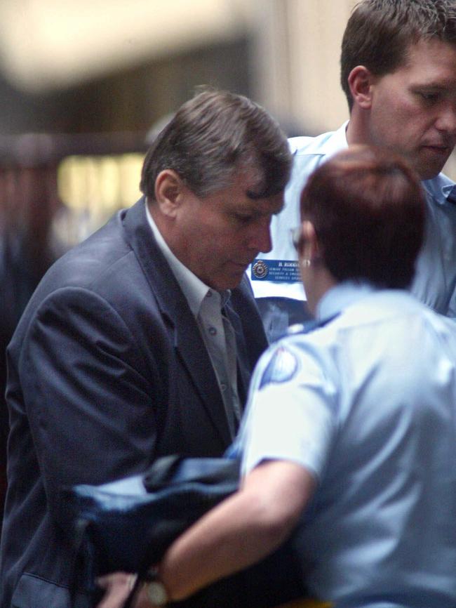 Bandali Michael Debs is led into a sentencing hearing in 2003. Picture: Kelly Barnes