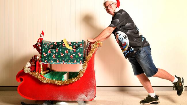 Colin Paine the mailman at the Townsville University Hospital has decorated his trolley as a Christmas Sleigh. Picture: Alix Sweeney