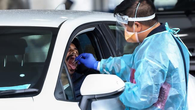 A motorist gets tested for coronavirus at a drivethrough site in Melbourne. Picture: Ian Currie