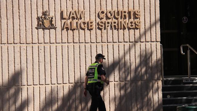 A Northern Territory police officer walks in front of the Alice Springs Local Court. Picture: Gera Kazakov