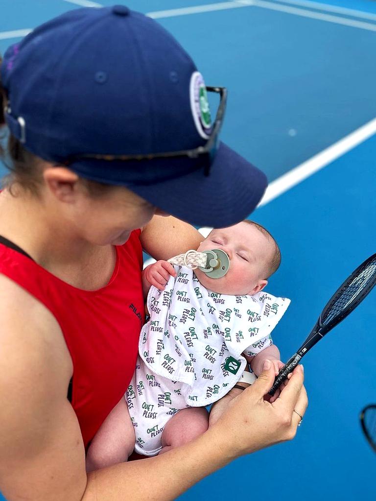 Ash Barty with her son Hayden and his tiny racquet. Picture Instagram