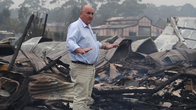 Emergency Services Minister David Elliott visits the devastated small town of Wingella just outside of Bundanoon on Sunday. Picture: David Swift