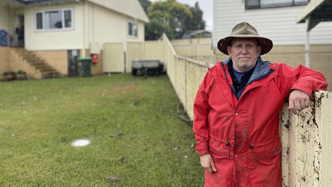 Jim McGregor is cleaning up his Peter Ave home after it flooded for the third time in a month at Camden. The dirt on the fence shows how high the waters rose. Picture: Annie Lewis