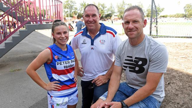 Central District SANFLW player Aisha Thomas, 16, with her dad <ld pattern="."/>– Bulldogs 153-gamer Jamie Thomas – and brother Paul Thomas, who captained Central and won a Magarey Medal. Aisha is keen to be writing her own story with the club. Picture: Tom Huntley