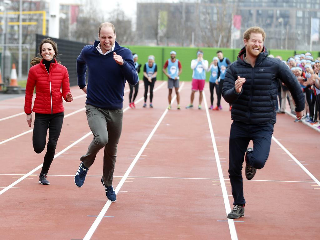 Catherine, the then Duchess of Cambridge, with Prince William and Prince Harry in a running race. (Photo by Alastair Grant / POOL / AFP)