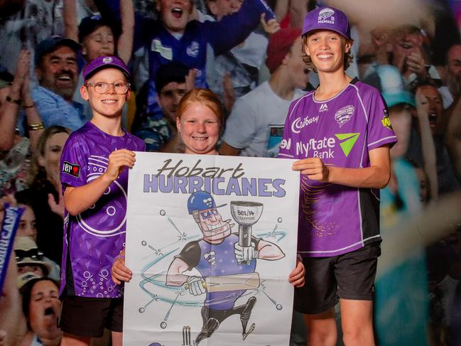 Hurricanes Fans Maverick Appleton, 11, Ellie Appleton, 8, and Flynn Beattie, 13, with the Mercury’s special edition Hurricanes poster at Ninja Stadium last week. Picture: Linda Higginson