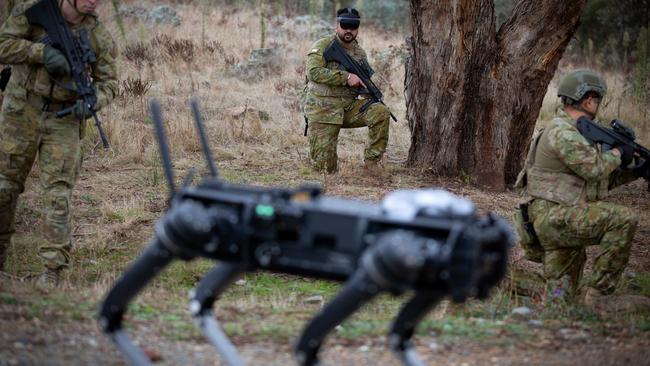 Australian Army soldier Sergeant Rana Chandan (centre) from the 1st/15th Royal NSW Lancers operates a Ghost Robotics quadruped robot using a brain-computer interface in May 2022. Picture: Sgt Matthew Bickerton