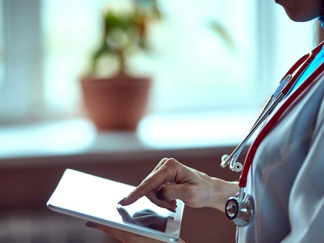 Woman doctor using tablet computer in hospital