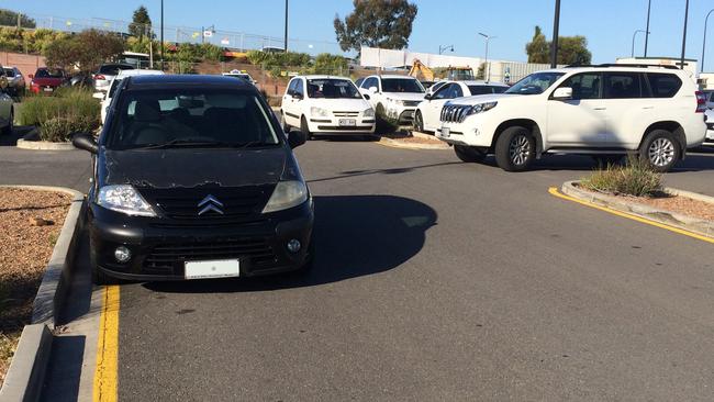 A car parked on a yellow line at Mawson Lakes Interchange.