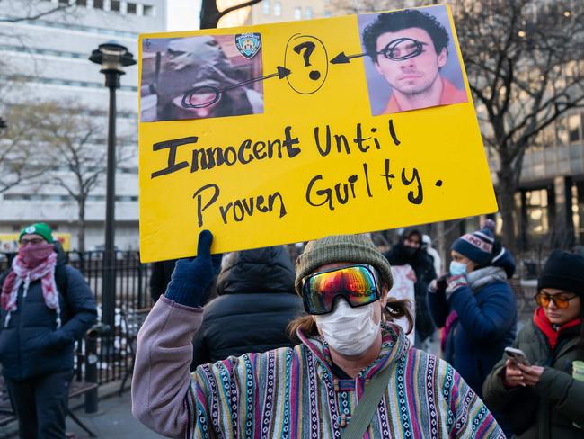 A protester holds a sign outside of Manhattan Criminal Court on December 23, 2024 in New York City. Picture: AFP