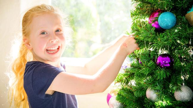 Annabel, 6, prepares baubles for the tree. Picture: Mark Stewart