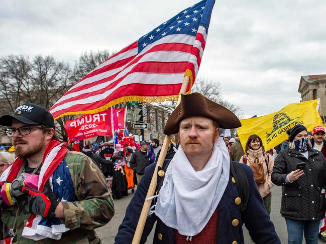 Supporters of US President Donald Trump march through the streets of the city as they make their way to the Capitol Building in Washington DC on January 6, 2021. - Donald Trump's supporters stormed a session of Congress held today, January 6, to certify Joe Biden's election win, triggering unprecedented chaos and violence at the heart of American democracy and accusations the president was attempting a coup. (Photo by Joseph Prezioso / AFP)