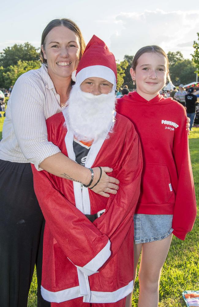 (From left) Chantal Royle, Hunter Lindenmayer and Adelyn Royle. Triple M Mayoral Carols by Candlelight. Sunday 8th December, 2024. Picture: Nev Madsen.