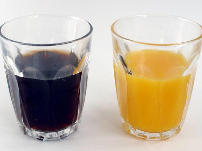 NOVEMBER 7, 2003 : A glass of coca-cola and a glass of orange juice, 07/11/03. Pic Jim Trifyllis.Food / Soft Drink / Coke