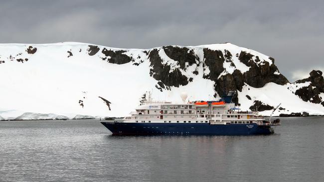 The Sea Spirit waits for trekkers in Orne Harbour, Antarctic Peninsula. Picture: AAP