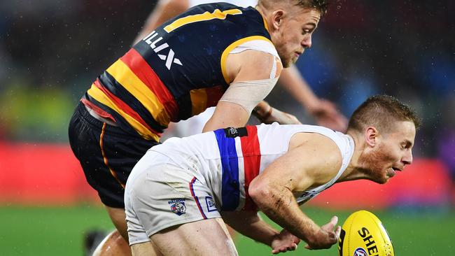 The Crows’ Hugh Greenwood hits Bulldog Lachie Hunter. Picture: Mark Brake/Getty Images