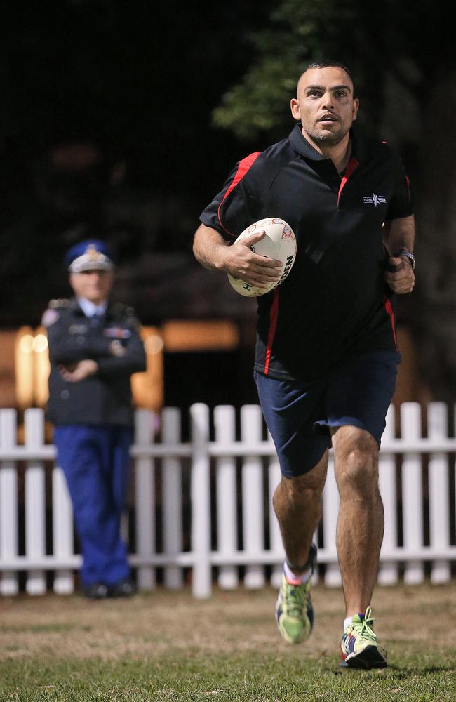 Sam Hampton, wearing an ankle bracelet, trains ahead of the footy match under the watchful eye of the Governor of Long Bay, Patrick Aboud. Picture: Sam Ruttyn