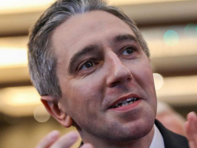 Simon Harris applauds during the Fine Gael convention at the Sheraton Hotel in Athlone, central Ireland on March 24, 2024, before being declared leader and de facto prime minister-in-waiting. Irish prime minister-in-waiting Simon Harris' takes over following the shock resignation of predecessor Leo Varadkar on Wednesday, a move pundits described as a 