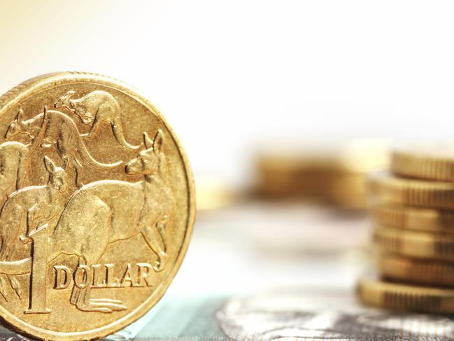 Generic photo of an Australian dollar coin .. Aussie one dollar coins, on a twenty dollar note.