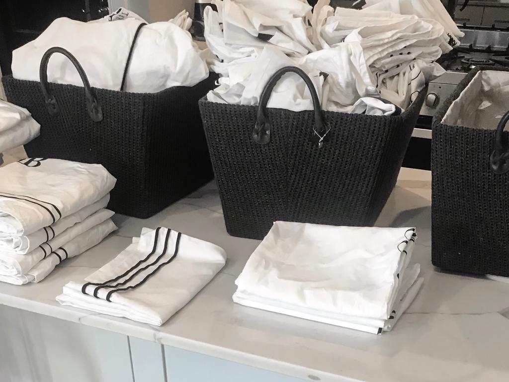 Tapered wicker baskets from Kmart made organising linen much easier.