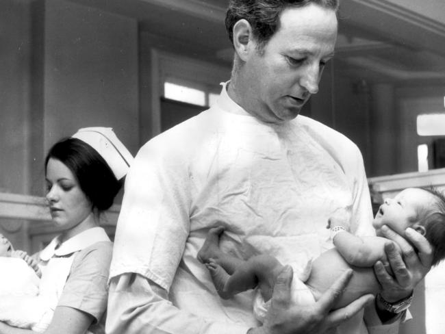 Obstetrician Dr William McBride holding a newborn baby at the then Crown Street Women's Hospital in Sydney, February 1972. He alerted the world to the dangers of thalidomide.