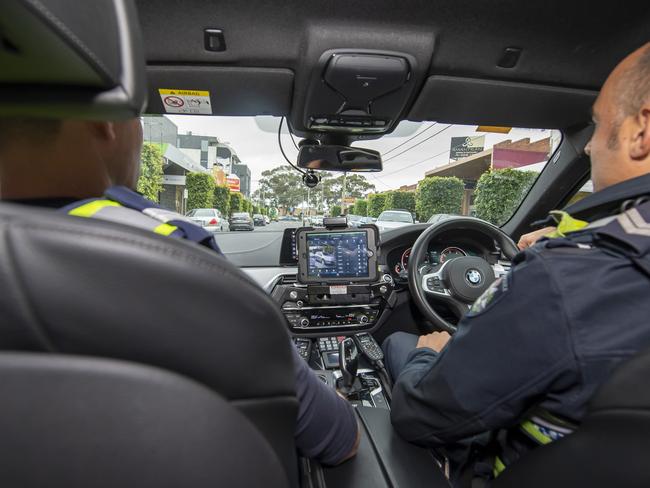 Senior Constables Dane Leach (left) and Ferdi Cokeleks use the new technology. Picture: Andy Brownbill