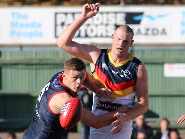 Norwood's Luke Surman works the ball away from Adelaide's Sam Jacobs. Picture: AAP Image/Russell Millard