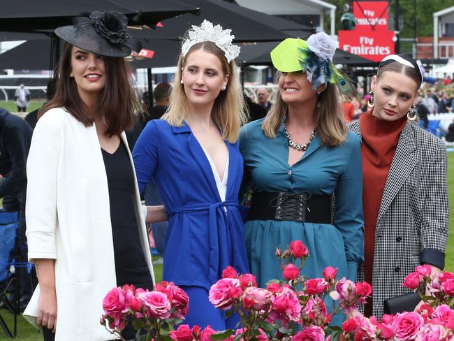 Stylish Melbourne Cup attendees take a moment to pose for a photograph. Picture: AAP Image/David Crosling